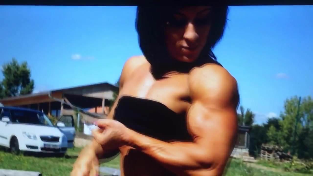 A sexy sassy stunning Woman Bodybuilder flexing her biceps