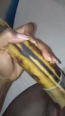 Ebony girl masturbates with a banana