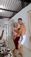 latin granny dances with young boy