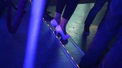 Candid dancing white high heels in a club